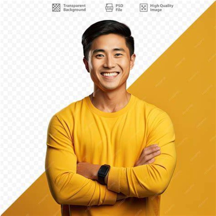a man in yellow and black is looking at his cell phone